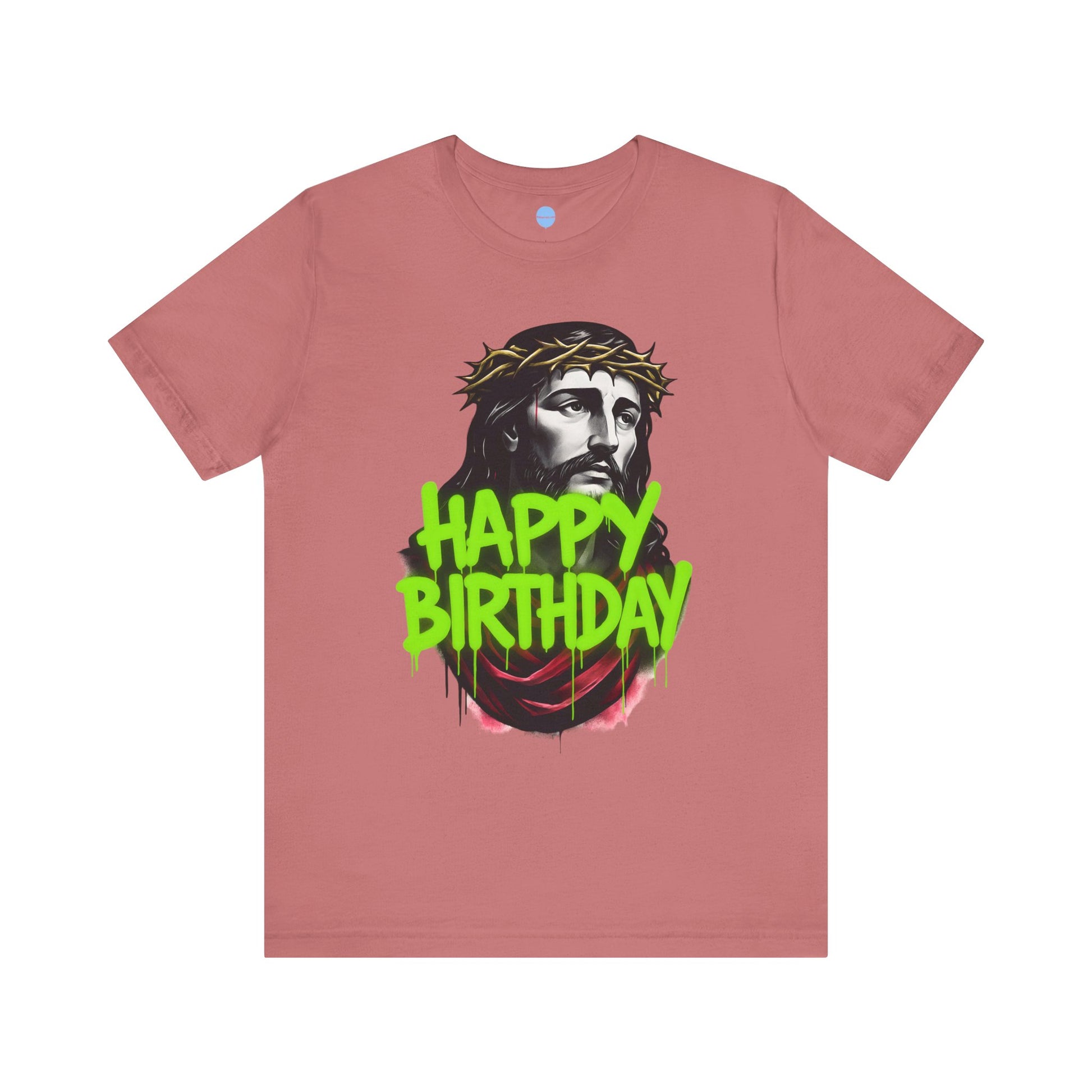 Pink t-shirt with a graphic of a Jesus wearing a crown of thorns and 'Happy Birthday' spray painted text on a white background.